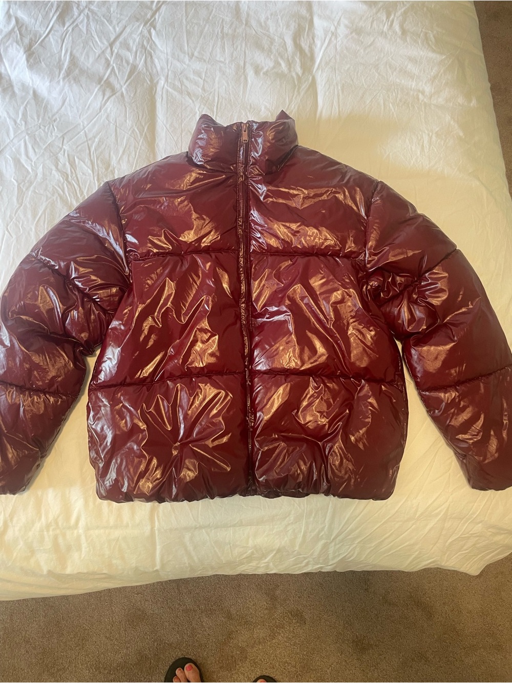 Puffer jacket in shiny water resistant burgundy exterior with satin interior.